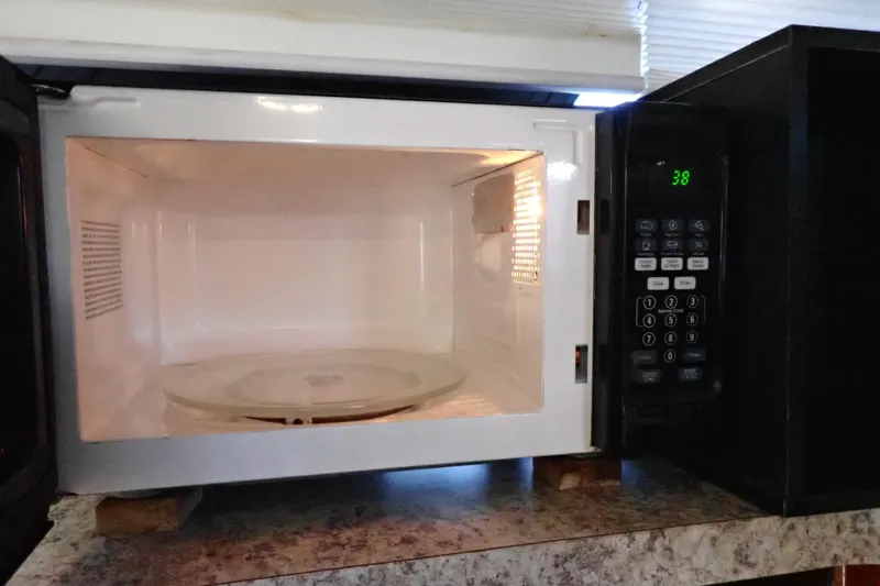 Slide: The Image of Open microwave oven with digital display showing 38 seconds on a kitchen countertop. - 63