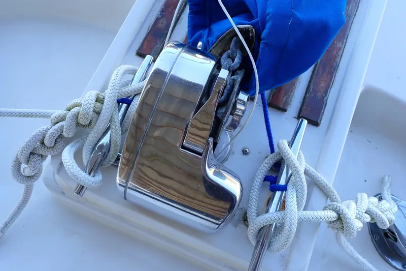 Slide: The Image of 1988 Mainship boat winch with ropes and blue cover on deck. - 7