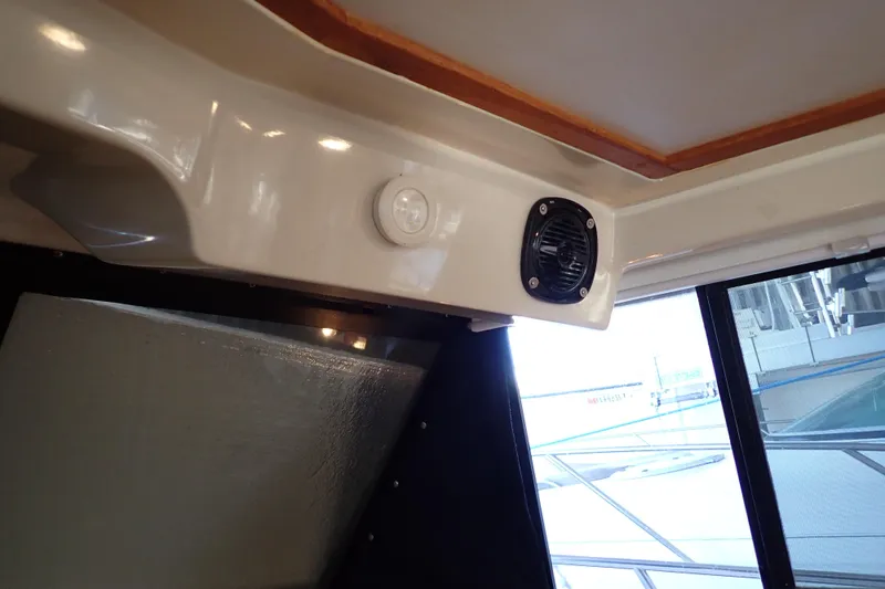 Slide: The Image of Interior of a 1988 Mainship boat showing a speaker and window. - 73