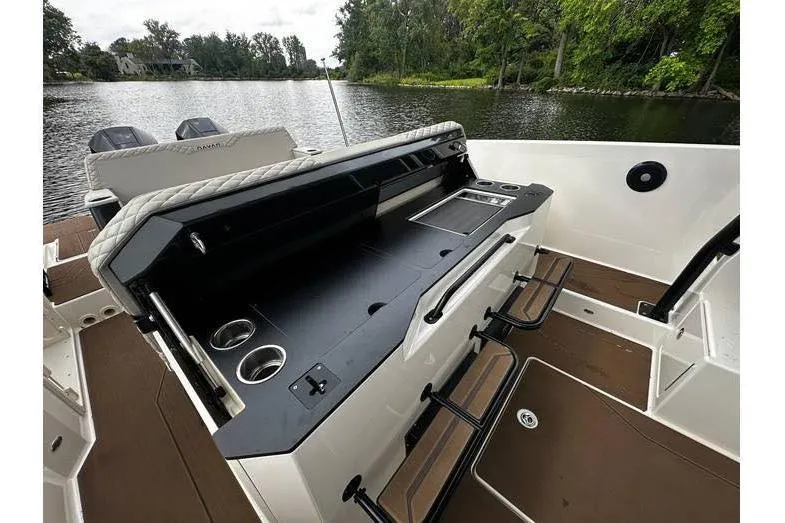 Slide: The Image of 2024 Navan S30 boat interior with sleek design, featuring a modern kitchenette and seating area. - 5