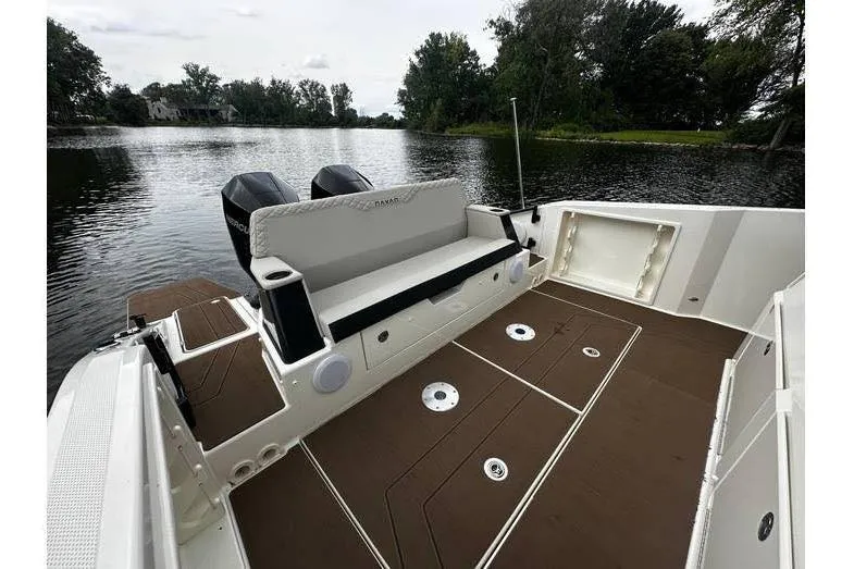 Slide: The Image of 2024 Navan S30 boat interior with seating and dual engines on a serene lake. - 6