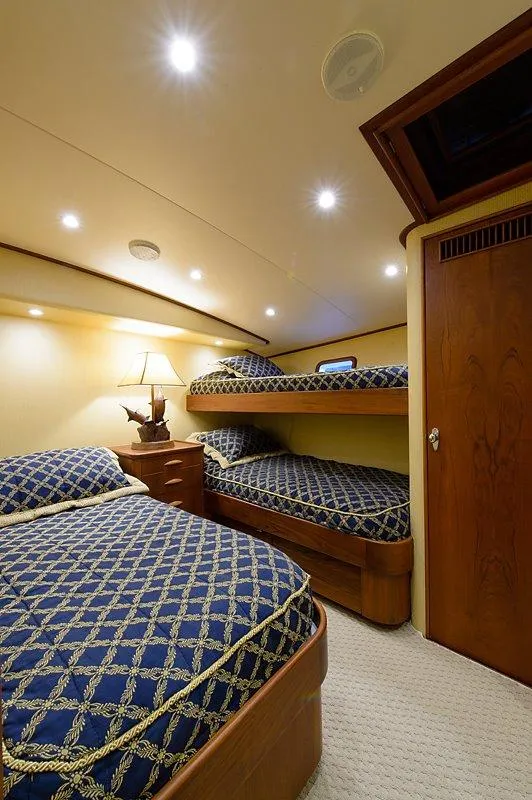 Slide: The Image of Luxurious cabin on 1987 Custom Carolina Merritt boat with elegant beds and lighting. - 35