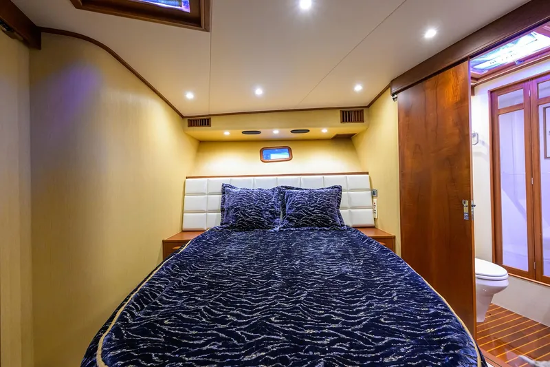Slide: The Image of Luxurious cabin interior of 1987 Merritt Sport Fisherman boat with plush bedding. - 39