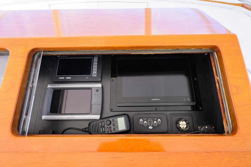 Slide: The Image of 1987 Merritt Sport Fisherman dashboard with Garmin navigation equipment and communication devices. - 14