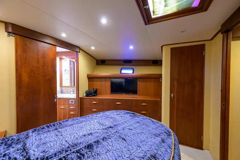 Slide: The Image of Luxurious cabin interior of 1987 Merritt Sport Fisherman boat with wood finishes and modern amenities. - 37