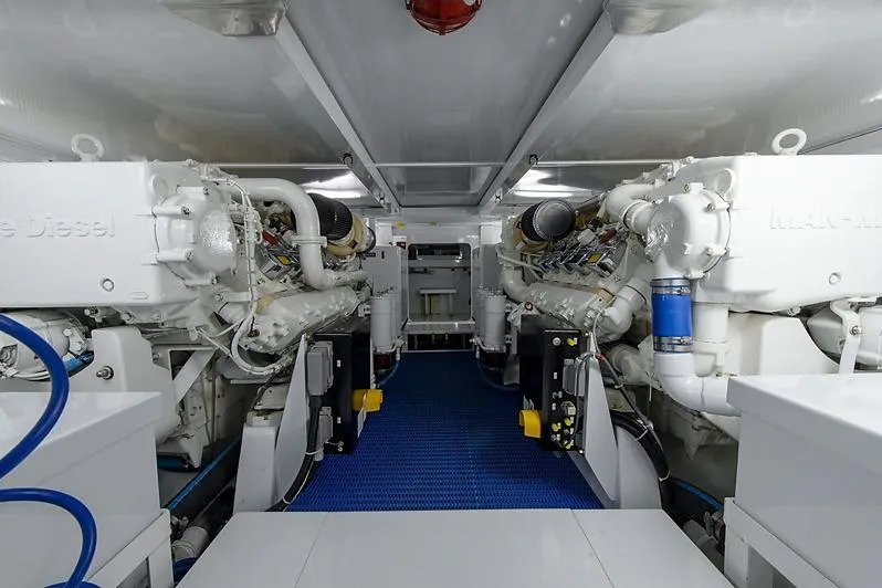 Slide: The Image of Engine room of a 1987 Merritt Boat Works Sport Fisherman, featuring dual marine diesel engines. - 58