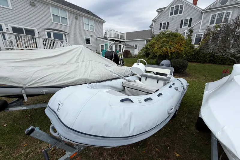 The Image of 2019 Highfield Classic 380 inflatable boat on trailer near residential homes. - 0