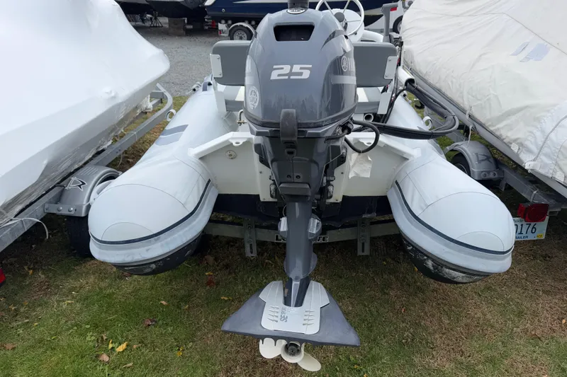Slide: The Image of 2019 Highfield Classic 380 inflatable boat with Yamaha 25 outboard motor, parked on grass. - 12