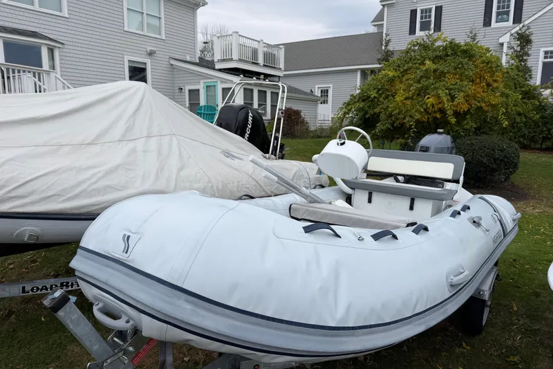 Slide: The Image of 2019 Highfield Classic 380 inflatable boat on trailer, parked near residential homes. - 4
