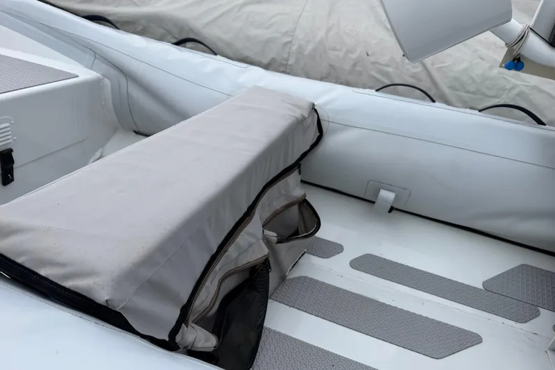 Slide: The Image of 2019 Highfield Classic 380 boat interior with cushioned seating and non-slip flooring. - 6