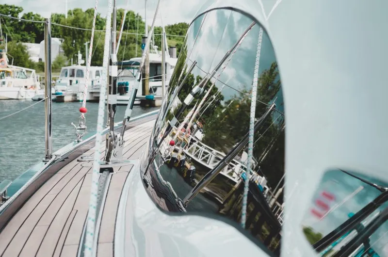 Slide: The Image of Sleek 2025 Southerly 480 yacht docked, reflecting marina scenery on its glossy surface. - 11