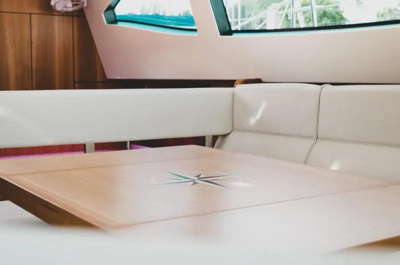 Slide: The Image of Luxurious interior of 2025 Southerly 480 yacht with elegant seating and wooden table. - 18