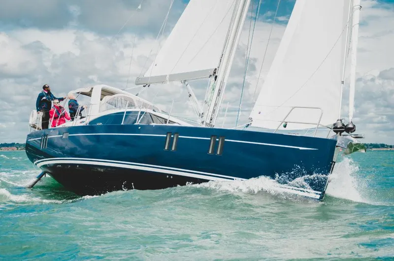Slide: The Image of 2025 Southerly 480 sailboat navigating through ocean waves under a cloudy sky. - 3