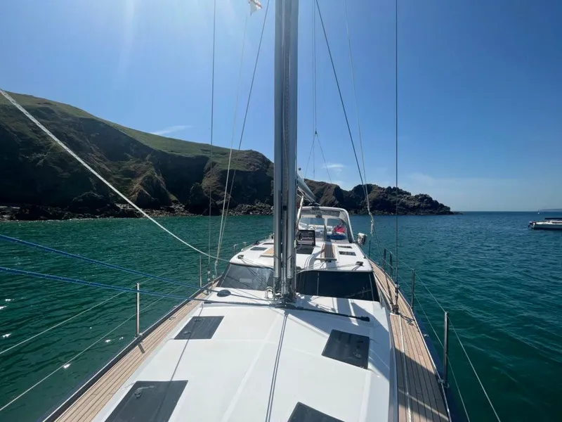 Slide: The Image of Sailing yacht Southerly 480 (2025) on calm waters near rocky coastline. - 34