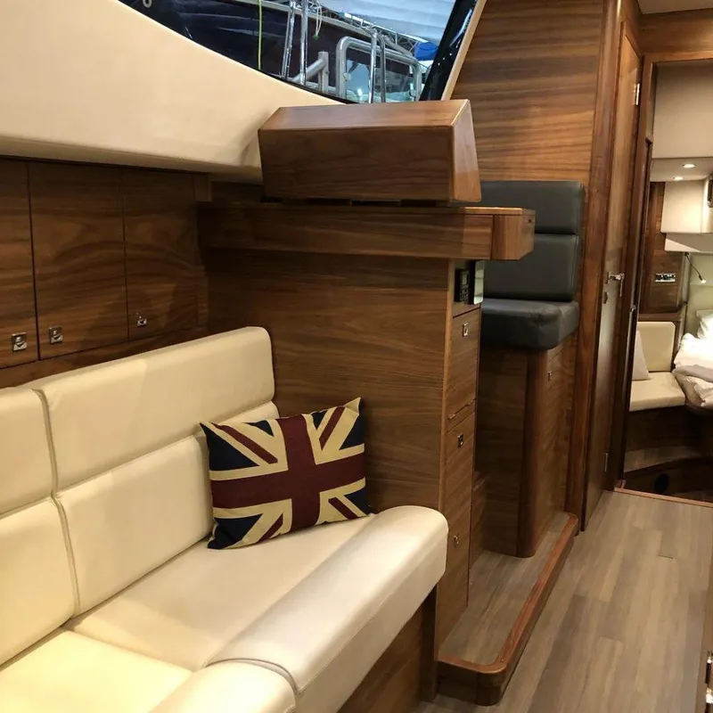 Slide: The Image of Luxurious interior of 2025 Southerly 480 yacht with wood finish and Union Jack pillow. - 38
