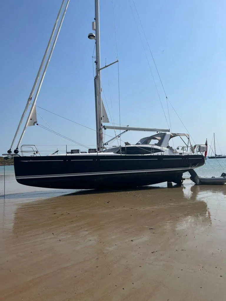 Slide: The Image of 2025 Southerly 480 yacht beached on sandy shore under clear blue sky. - 8