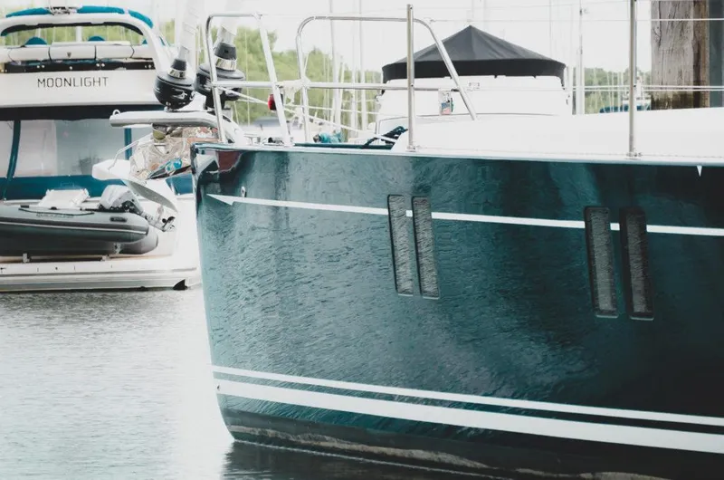 Slide: The Image of Southerly 480 yacht, 2025 model, docked near another boat named Moonlight. - 9