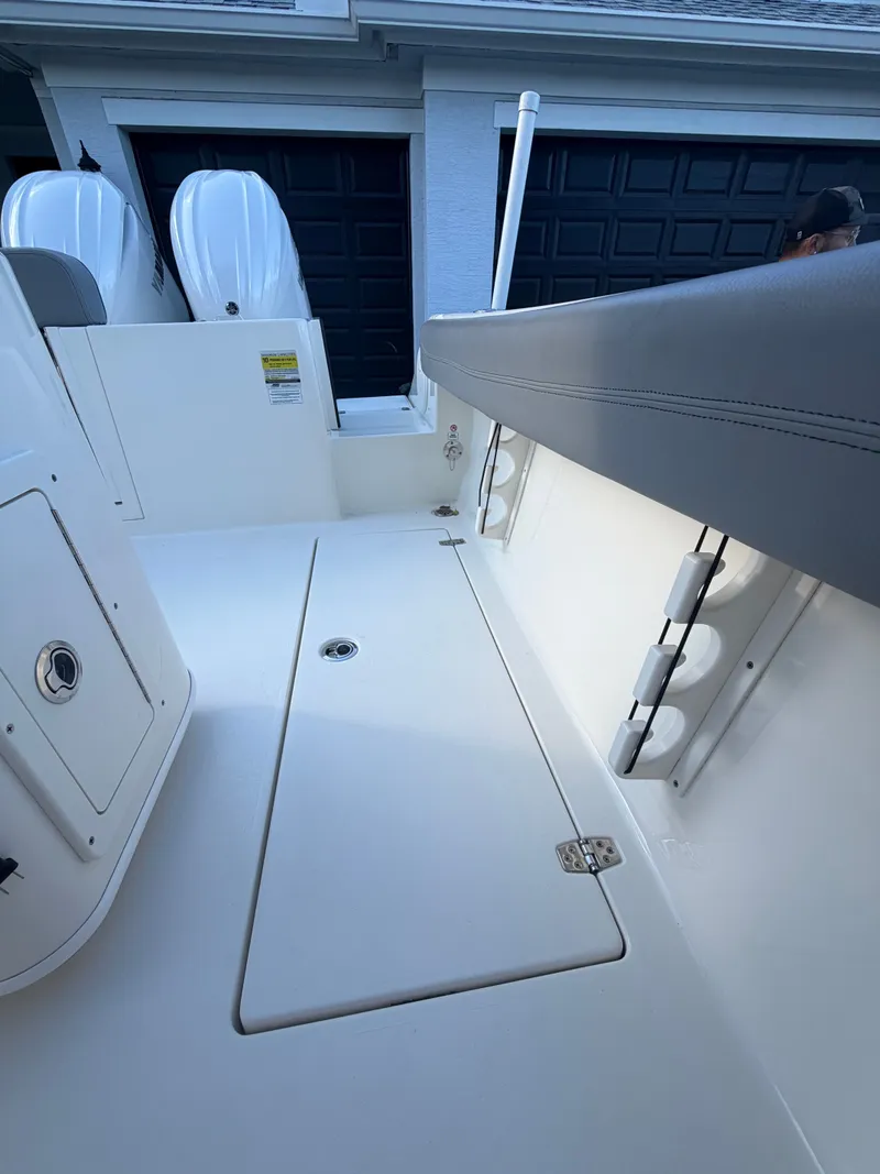 Slide: The Image of 2024 Cobia 240 Center Console boat deck with storage. - 10