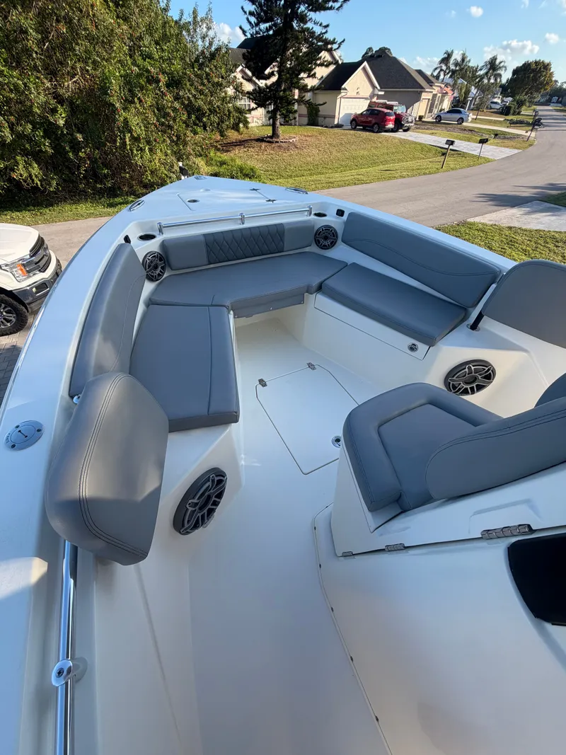 Slide: The Image of 2024 Cobia 240 Center Console with gray seating and speakers. - 13