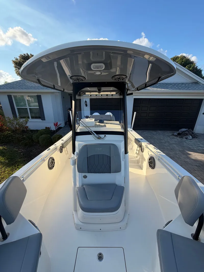 Slide: The Image of 2024 Cobia 240 Center Console boat parked outdoors. - 14