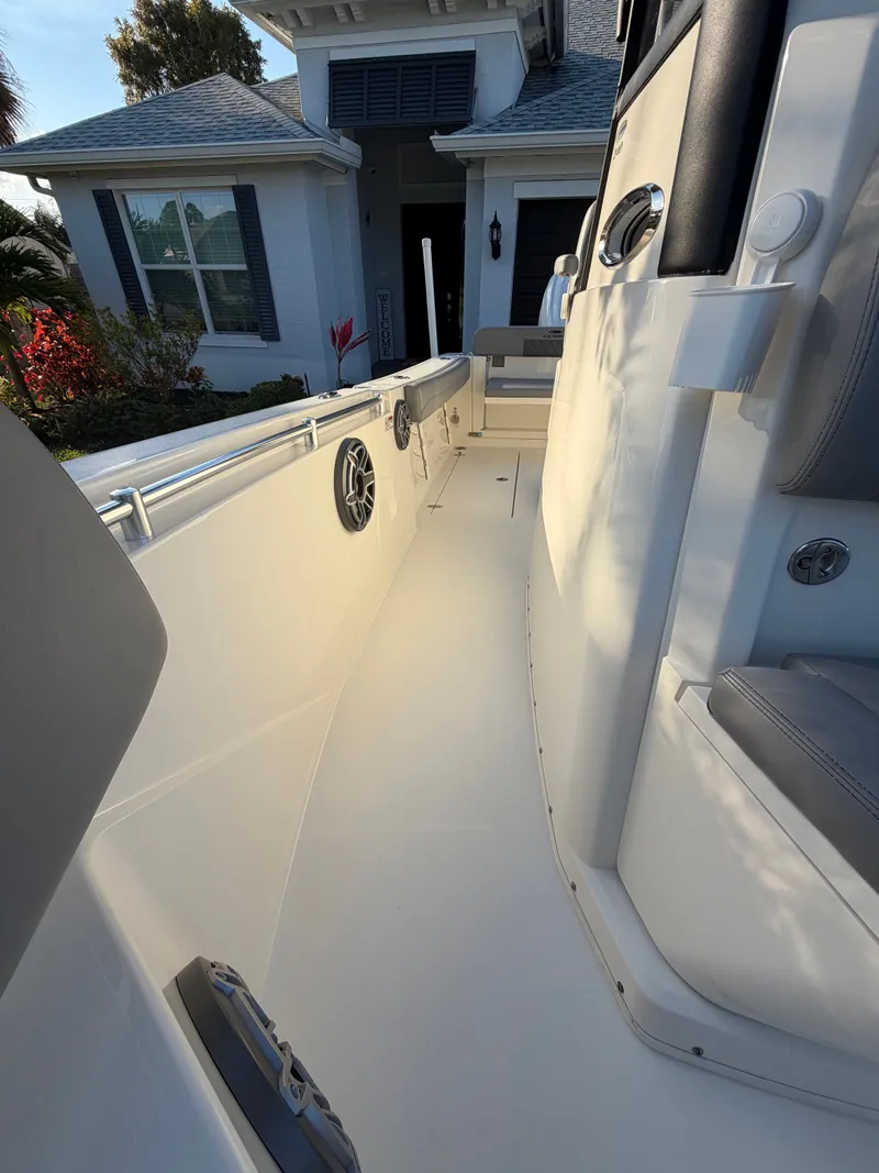 Slide: The Image of 2024 Cobia 240 Center Console boat beside a house. - 16