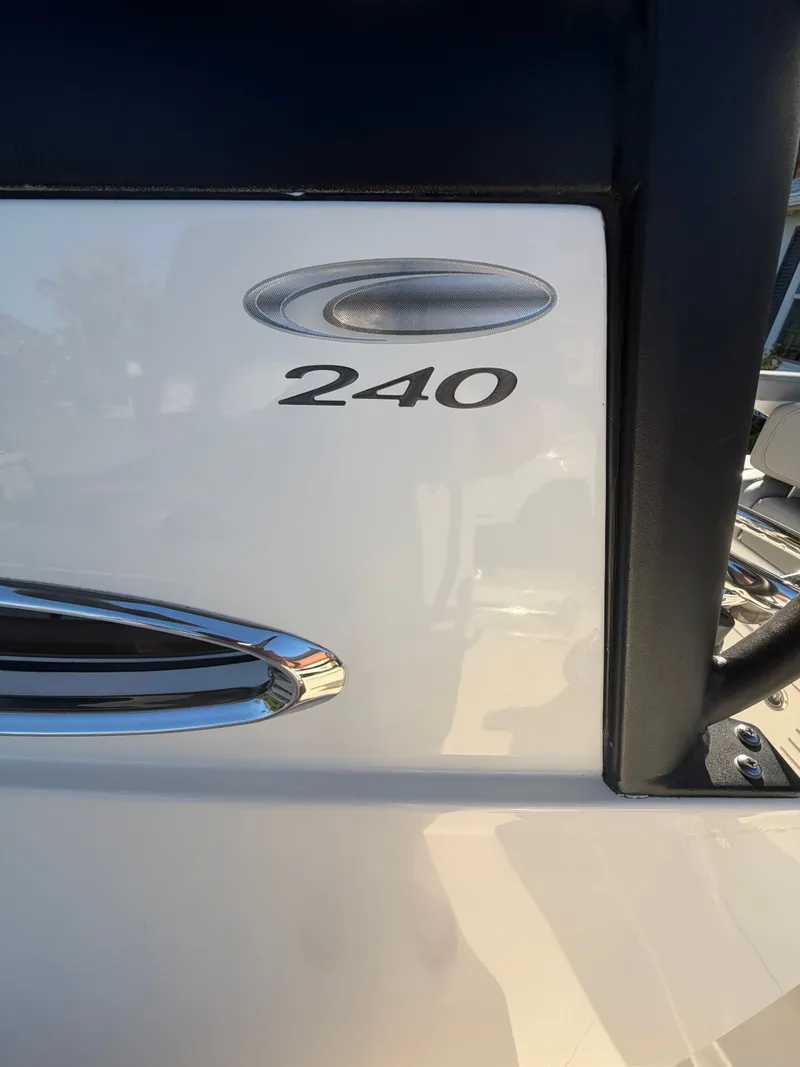Slide: The Image of Close-up of 2024 Cobia 240 Center Console boat logo. - 26
