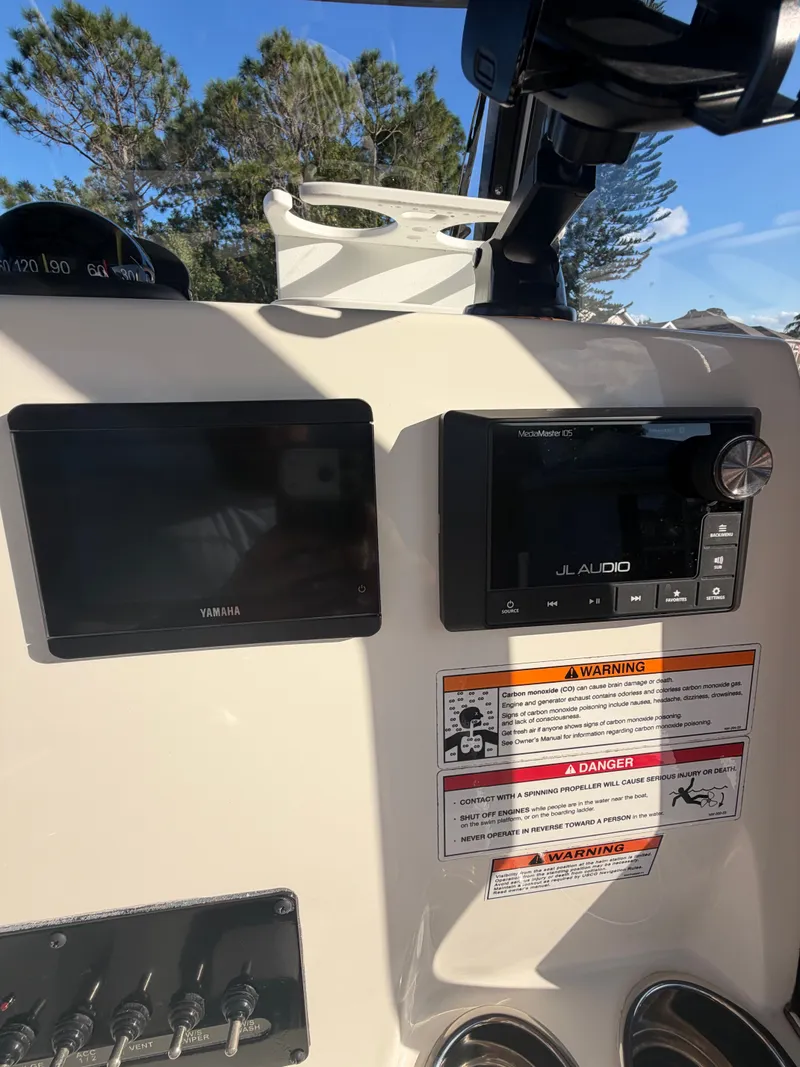 Slide: The Image of 2024 Cobia 240 Center Console dashboard with Yamaha and JL Audio equipment. - 9