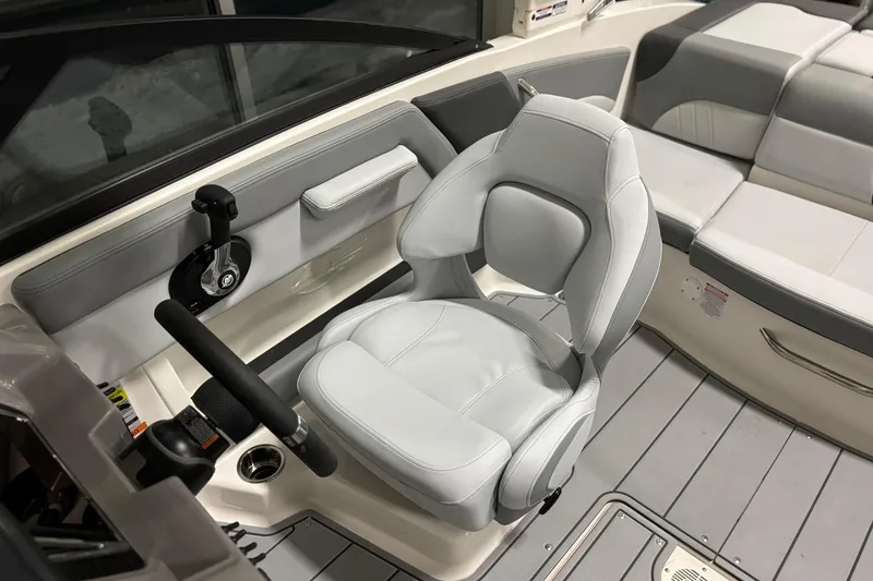 Slide: The Image of 2026 Chaparral 21 SSi boat interior with sleek captain's chair and modern controls. - 11
