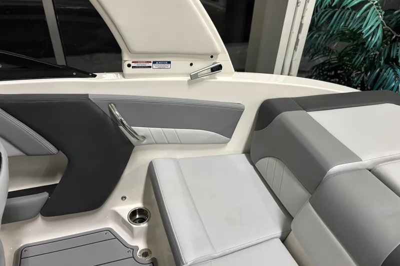 Slide: The Image of 2026 Chaparral 21 SSi boat interior with gray and white seating, modern design. - 22