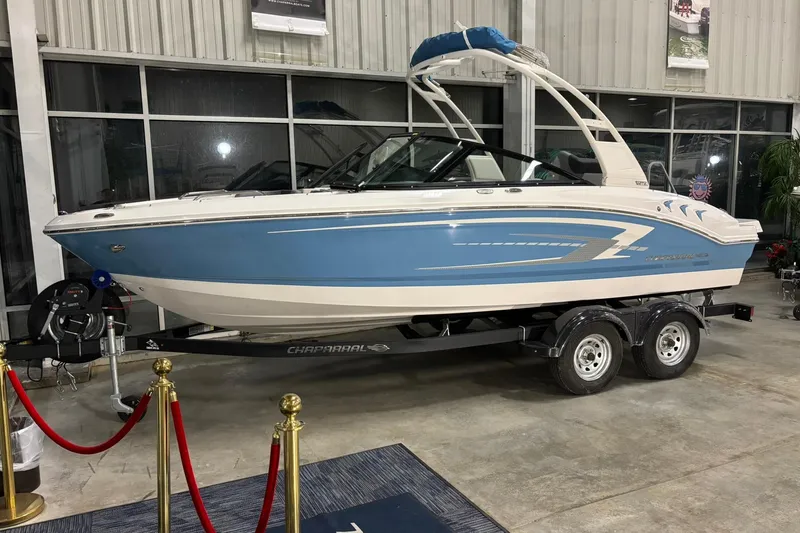 Slide: The Image of 2026 Chaparral 21 SSi boat displayed indoors on a trailer. - 24
