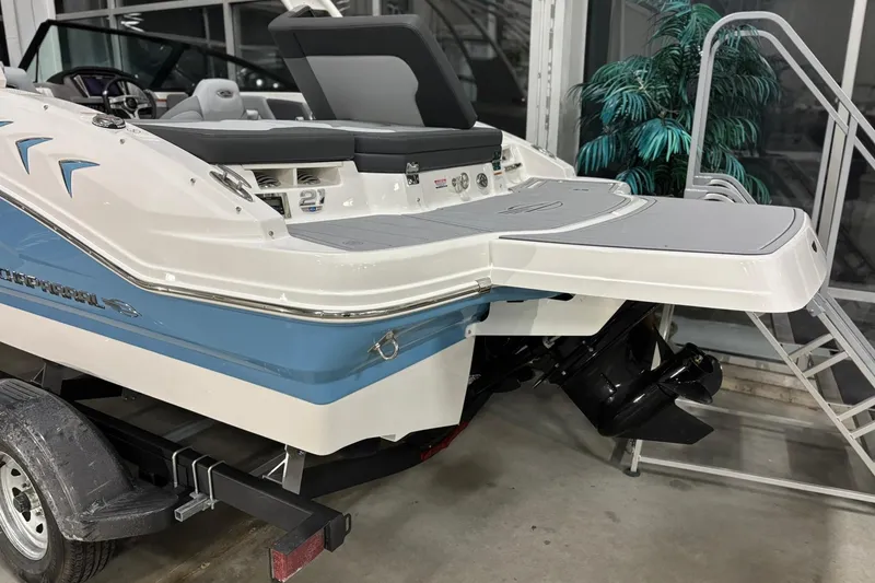 Slide: The Image of 2026 Chaparral 21 SSi boat rear view with swim platform and trailer. - 25