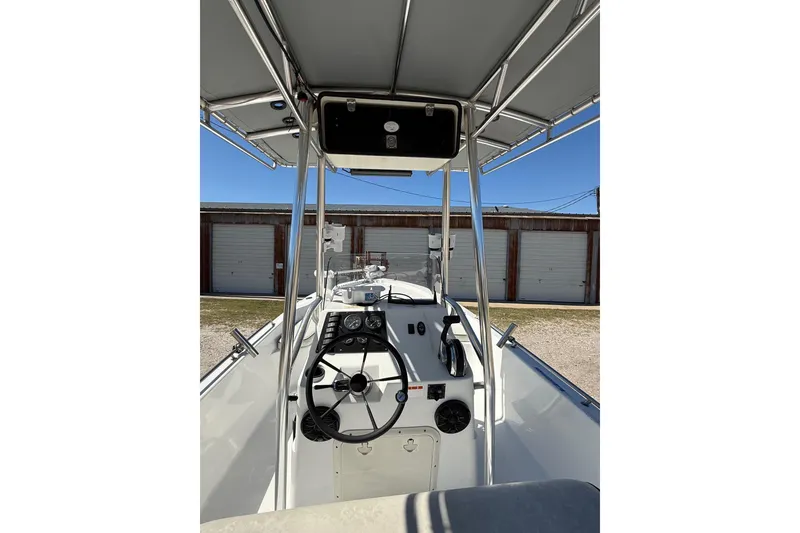 Slide: The Image of 2003 Kenner 21 V Tunnel boat with Mercury outboard motor, docked outdoors. - 12