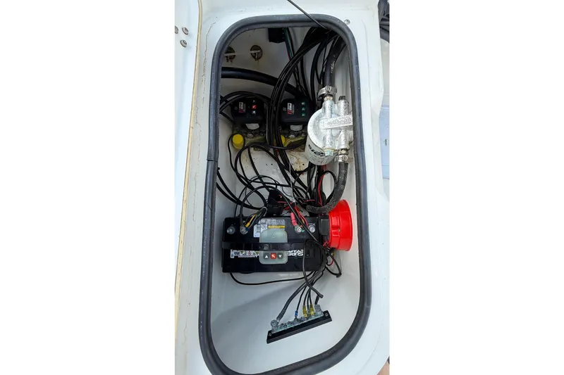 Slide: The Image of 2003 Kenner 21 V Tunnel boat compartment with battery and wiring. - 15