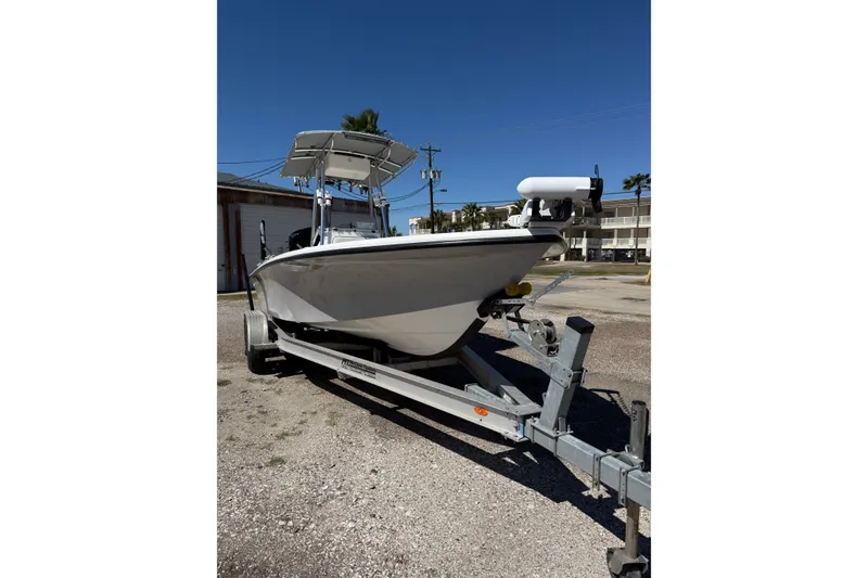 Slide: The Image of 2003 Kenner 21 V Tunnel boat on trailer under clear blue sky. - 5