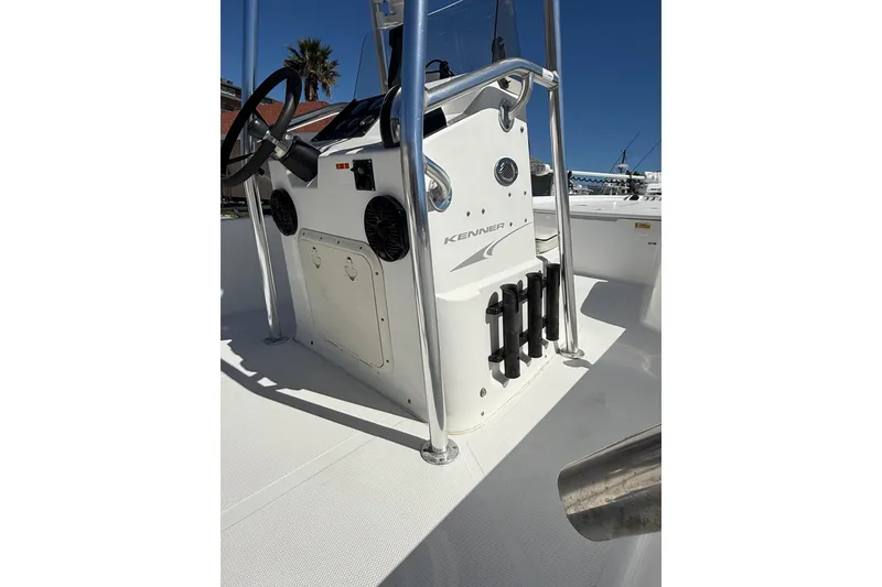 Slide: The Image of 2003 Kenner 21 V Tunnel boat console with steering wheel and rod holders. - 9
