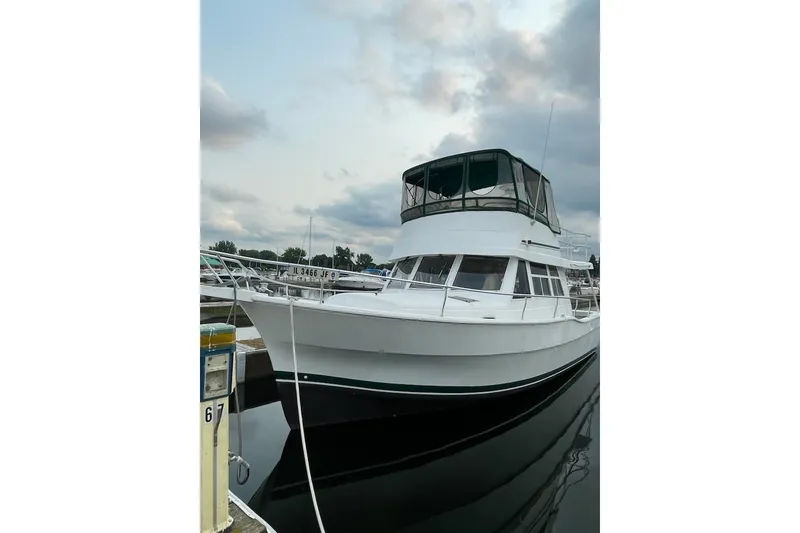 Slide: The Image of 1997 Mainship 350 Trawler docked at marina under cloudy sky. - 1