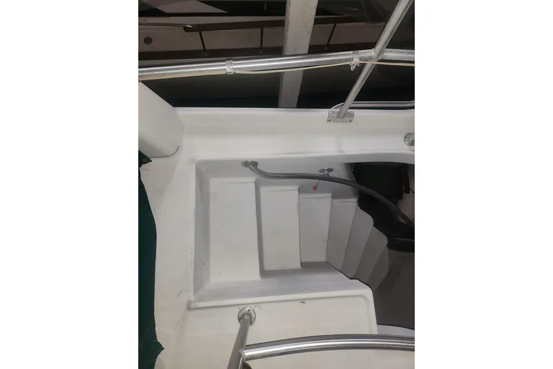 Slide: The Image of 1997 Mainship 350 Trawler stairs with metal railing, viewed from above. - 7