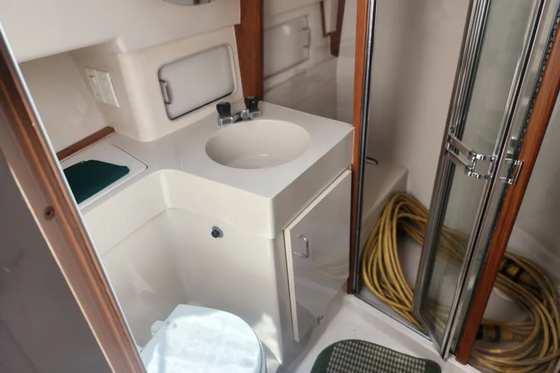 Slide: The Image of Bathroom interior of a 1997 Mainship 350 Trawler with sink and shower. - 22
