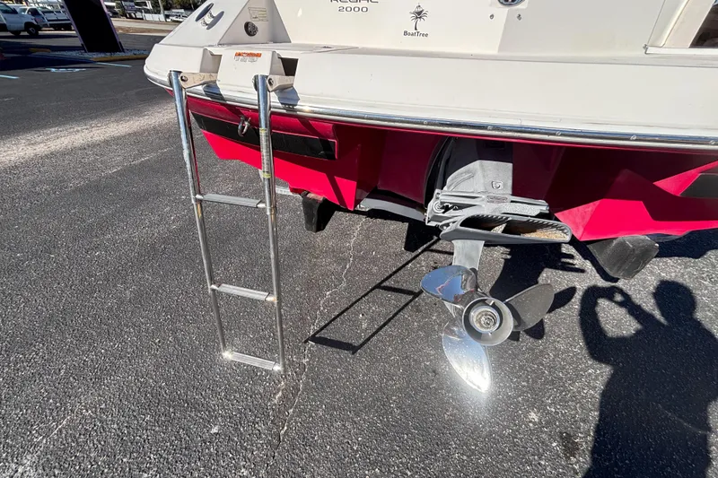 Slide: The Image of 2008 Regal 2000 Bowrider boat stern with ladder and propeller in sunlight. - 12