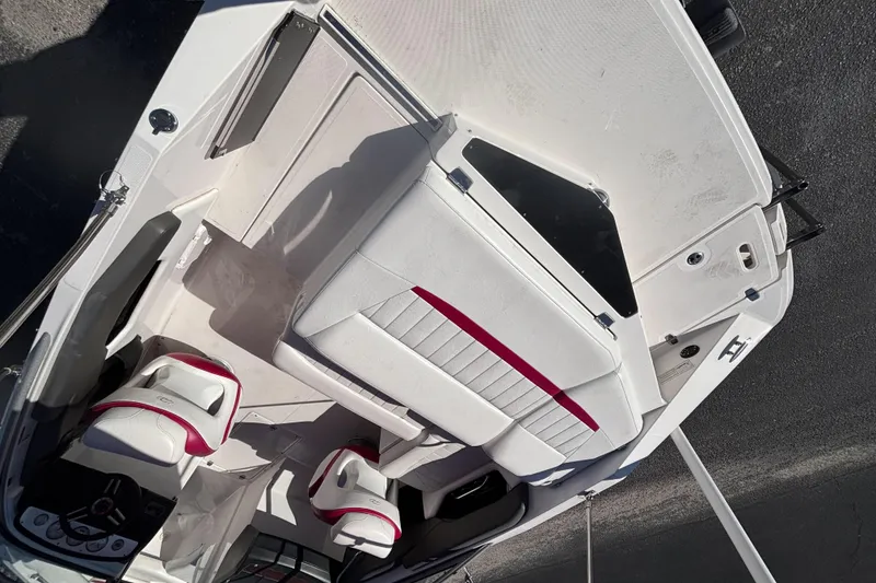 Slide: The Image of 2008 Regal 2000 Bowrider interior with white and red seating, steering wheel, and dashboard. - 13