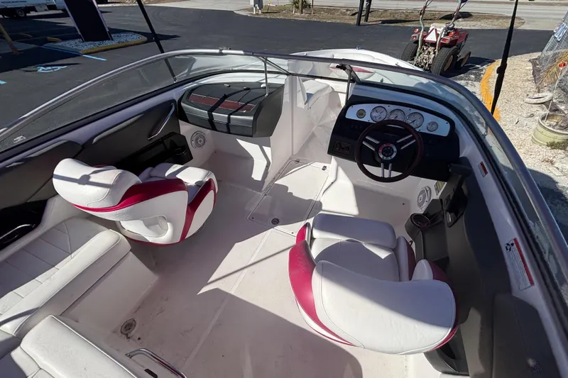 Slide: The Image of 2008 Regal 2000 Bowrider interior with white and red seating, dashboard, and steering wheel. - 16