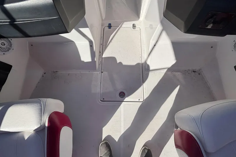 Slide: The Image of Interior of a 2008 Regal 2000 Bowrider boat, featuring white and red seating. - 22