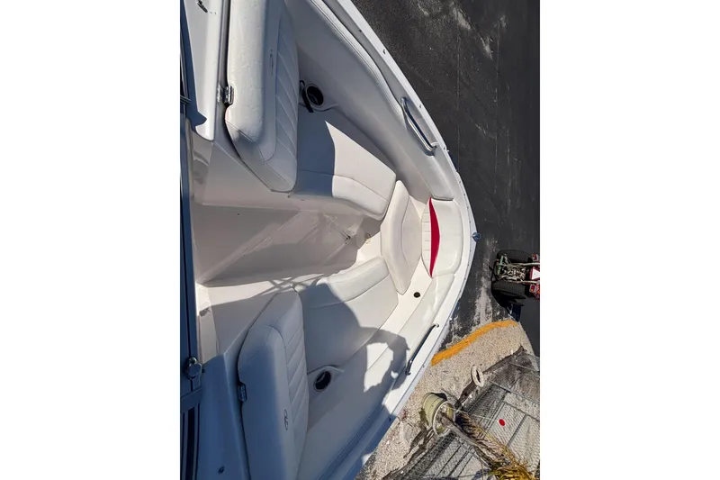Slide: The Image of 2008 Regal 2000 Bowrider boat interior with white seating and red accents. - 23
