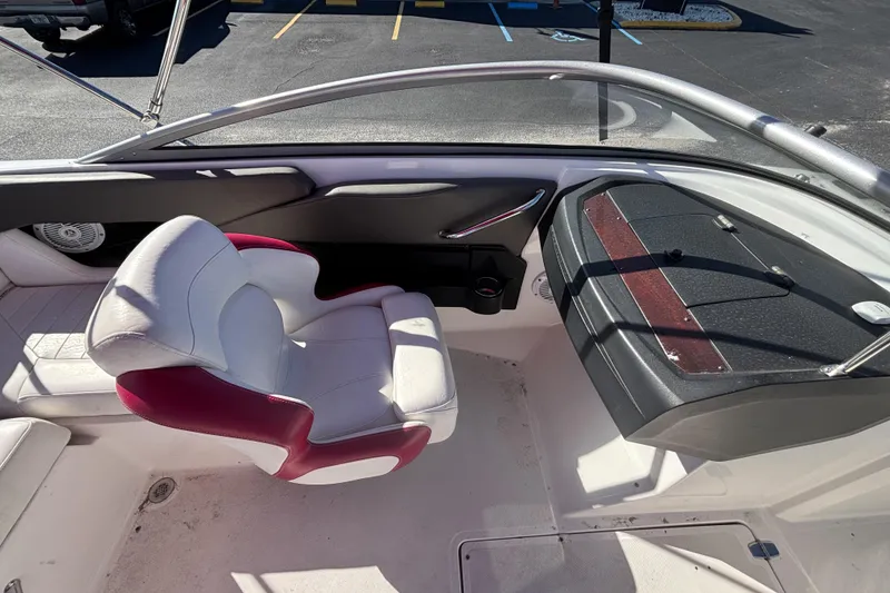 Slide: The Image of 2008 Regal 2000 Bowrider interior with white and red seating, dashboard view. - 25