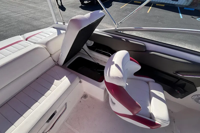 Slide: The Image of 2008 Regal 2000 Bowrider interior with white and red seating, open storage compartment. - 33