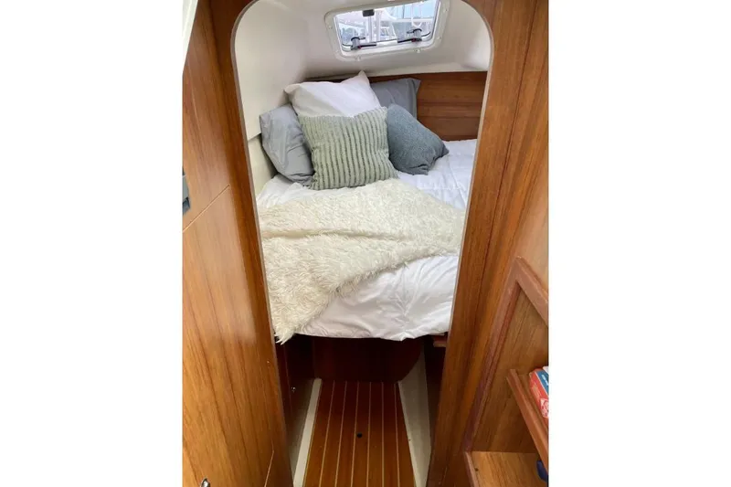 Slide: The Image of Cozy cabin interior of 2019 Gemini Freestyle 399 Power boat with plush bedding. - 2