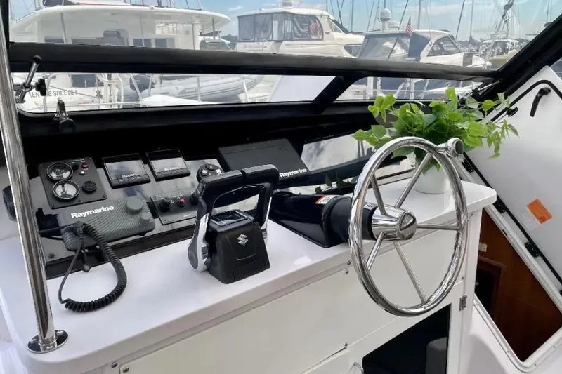 Slide: The Image of 2019 Gemini Freestyle 399 Power boat helm with steering wheel and navigation controls. - 3