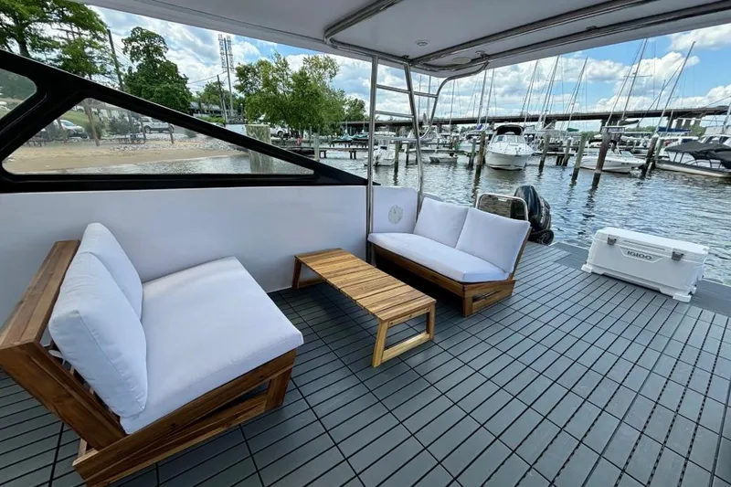 Slide: The Image of Outdoor seating on 2019 Gemini Freestyle 399 Power boat, docked at marina with scenic view. - 5