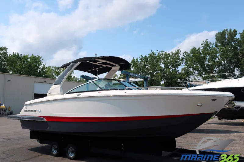 The Image of 2021 Chaparral 267 SSX boat on display outdoors, featuring sleek design and modern features. - 0