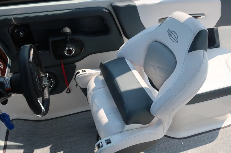 Slide: The Image of 2021 Chaparral 267 SSX boat interior with steering wheel and captain's seat. - 14